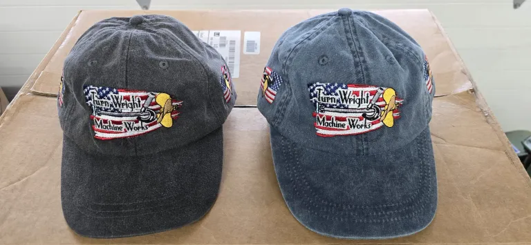 Two hats with a bee and american flag on them.