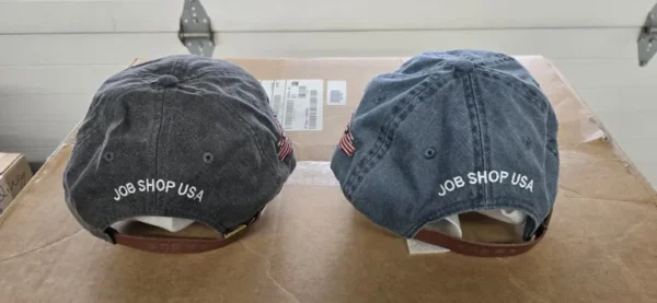 Two hats are sitting on a table.