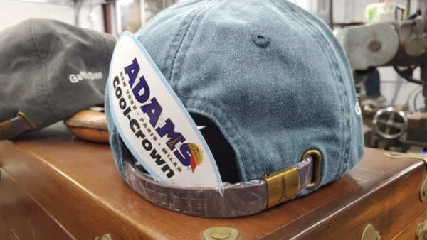 A hat with an adams cool crown logo on it.