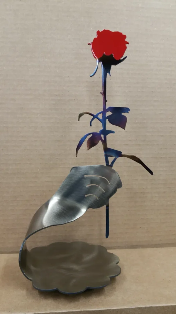 A metal leaf sculpture with blue and purple leaves.