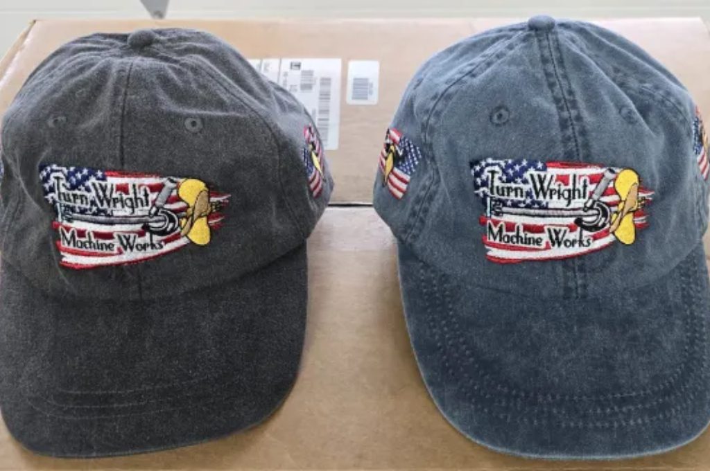 Two hats are sitting side by side on a table.