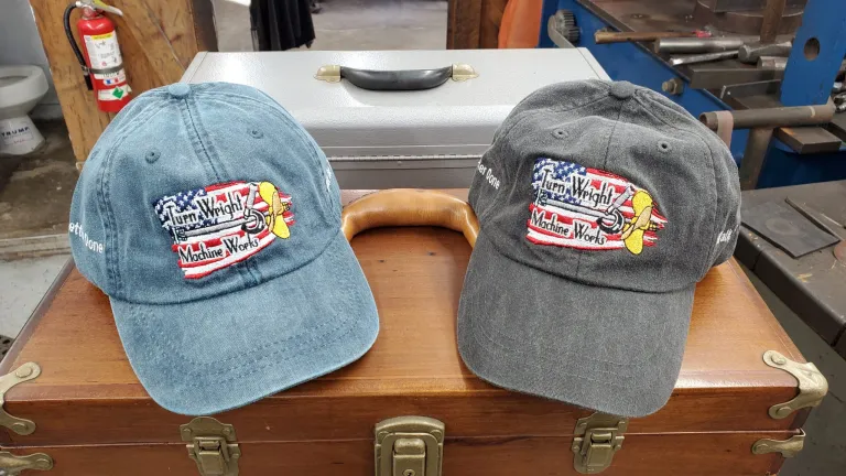 Two hats are sitting on a wooden box.