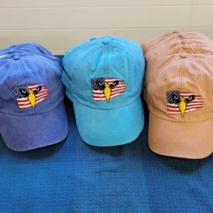 Three hats are sitting on a blue blanket.