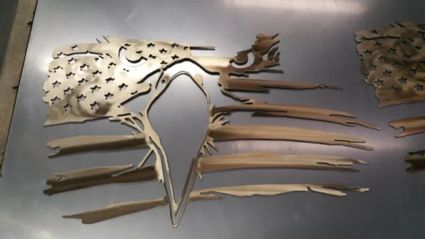 A metal sculpture of a bird with wings spread.