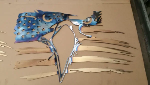 A bird is cut out of metal and placed on the wall.